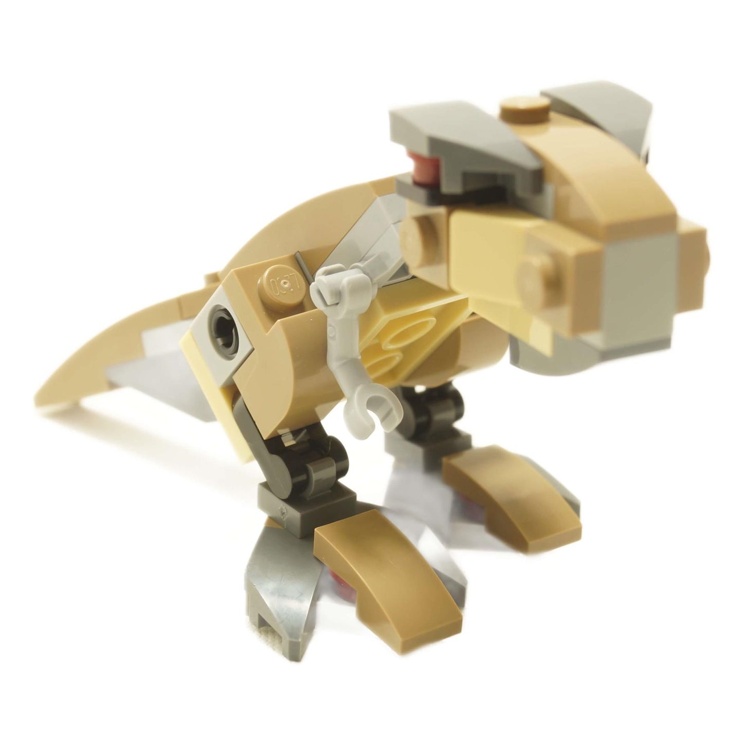 LEGO® mini Tyrannosaurus Rex brick-built dinosaur in tan and light gray with small articulated legs, short arms, and hinged jaw
