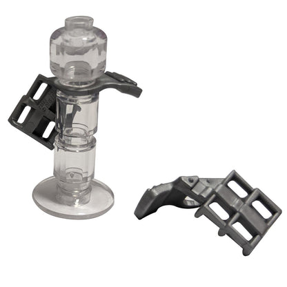 A LEGO minifigure armor shoulder pad with a scabbard for two katanas, made of clear plastic.