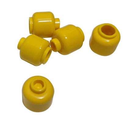 Plain yellow minifigure head with smooth cylindrical shape, stud on top and hollow underside