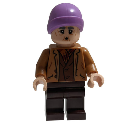  LEGO Harry Potter Mr. Flume minifigure shown from the front. He is wearing a brown jacket, a purple beanie hat, and has a gentle, aged expression.