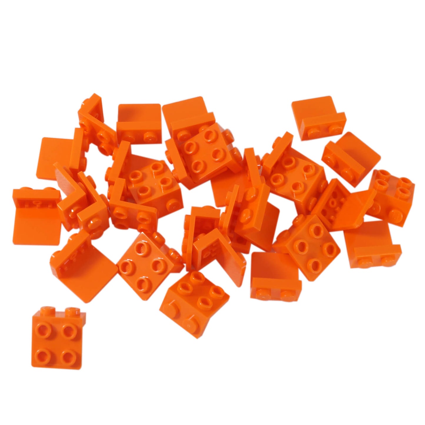 Pile of orange LEGO Bracket 1x2 - 2x2 pieces (44728) with one piece separated at the bottom left.