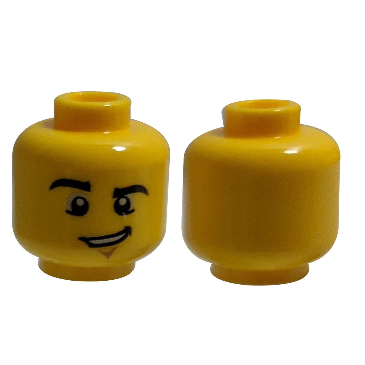 LEGO® Minifigure Head (3626pb0857), Yellow, with black eyebrows, a lopsided grin, and a chin dimple.