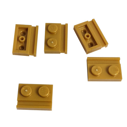 Pearl gold modified Plate 1 x 2 with door rail for sliding doors, track guides, and compact wall builds
