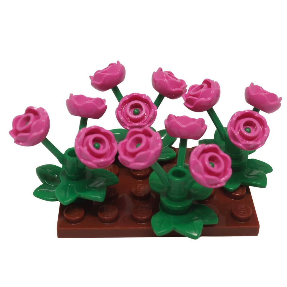 LEGO pink rose flower garden display build with green plant stems and reddish brown base