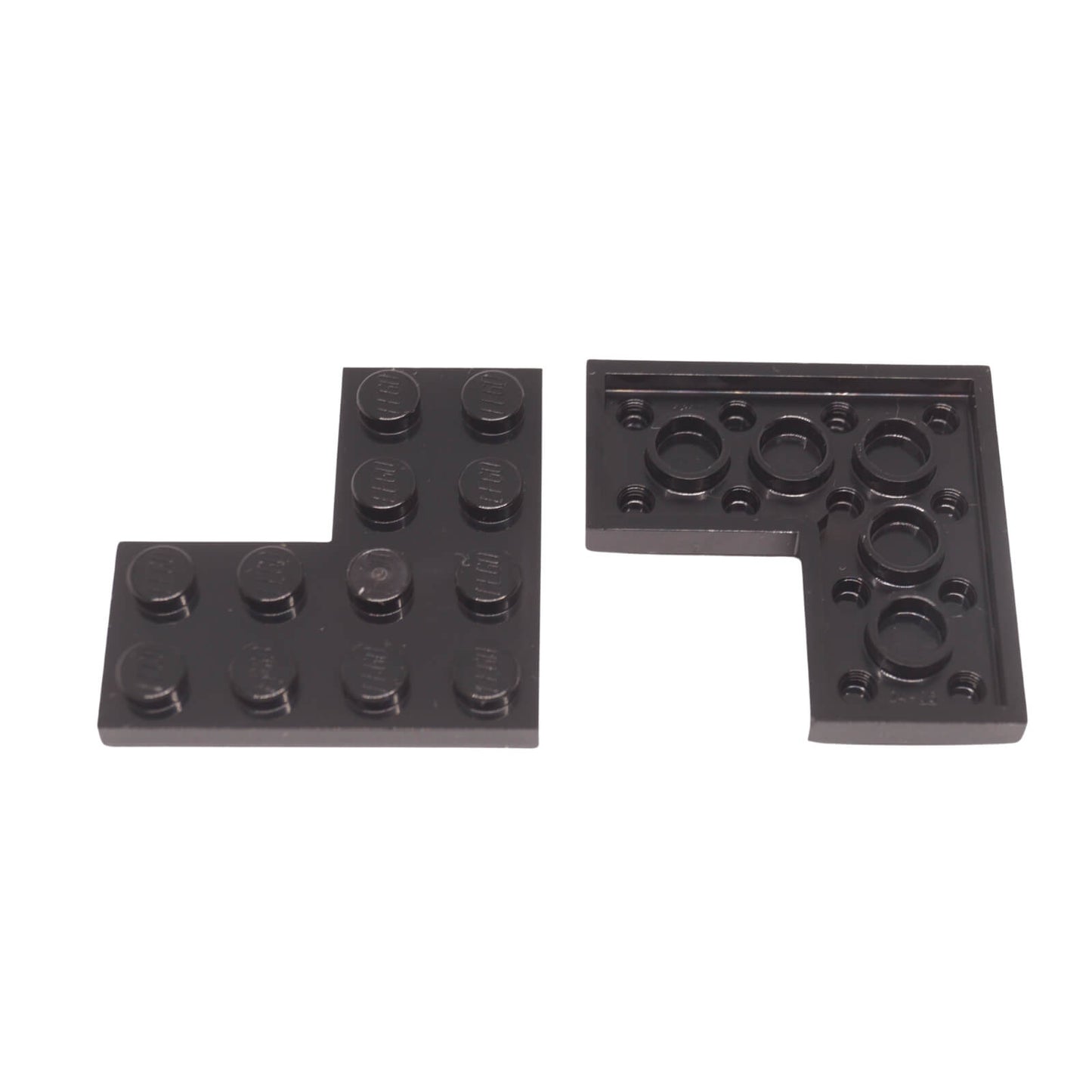 Black LEGO® plate 4x4 corner piece part 2639 with right angle cut-out close-up view