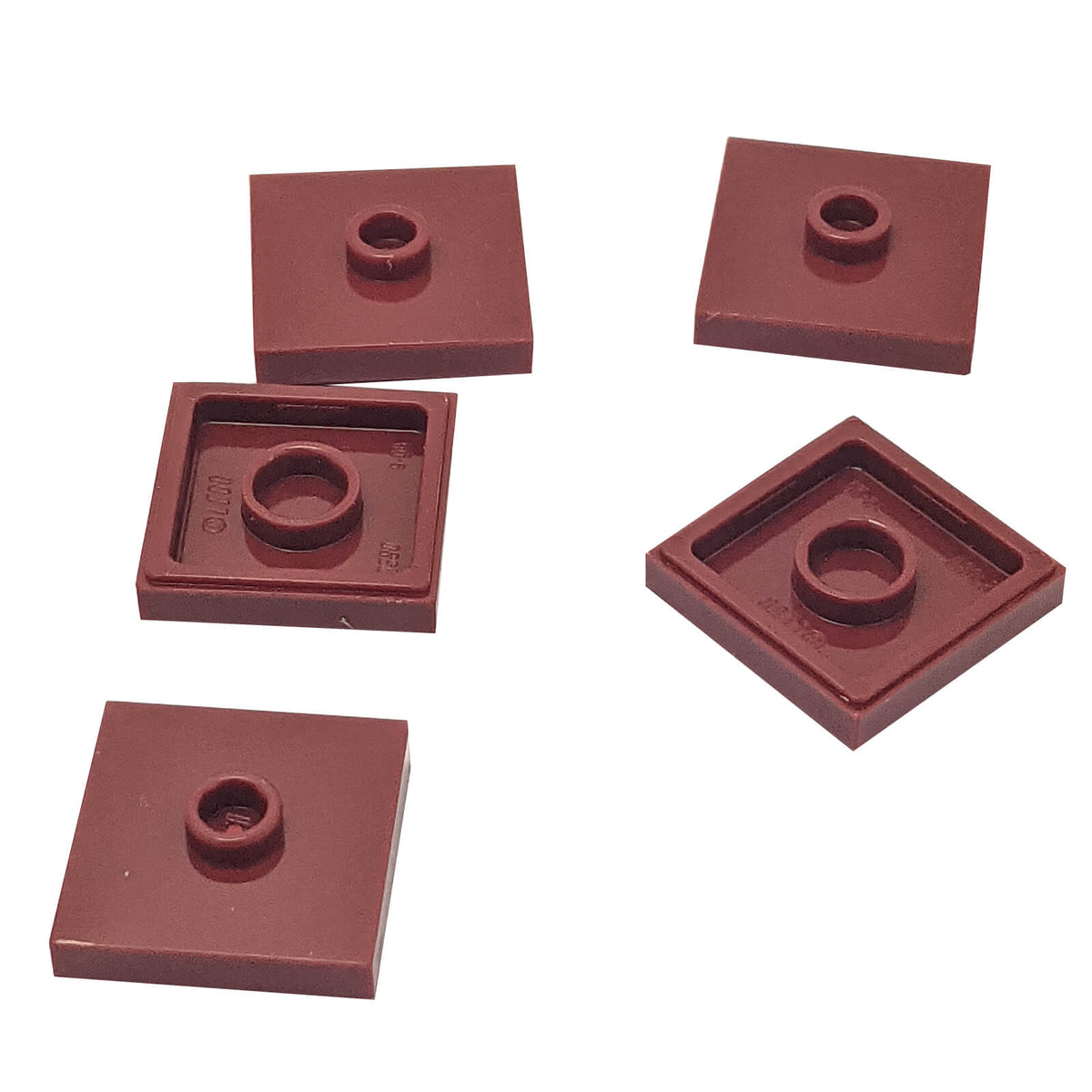LEGO Plate Modified 2 x 2 with Groove and 1 Stud in Center part 87580 shown from top and underside reddish brown