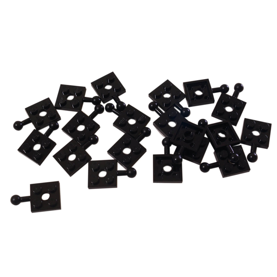 LEGO® plaque modifiée 2 x 2 avec boule d'attelage et trou en noir, utilisée pour les joints et les constructions articulées
