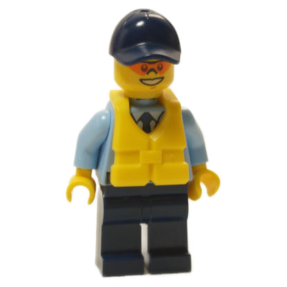 A LEGO minifigure representing a police officer wearing a yellow life jacket and a navy blue cap.