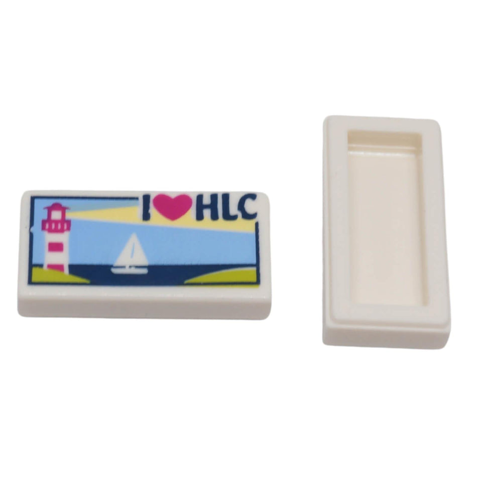 LEGO® printed 1 x 2 tile 3069pb0382 with lighthouse, sailboat and I Heart HLC design shown from front and back