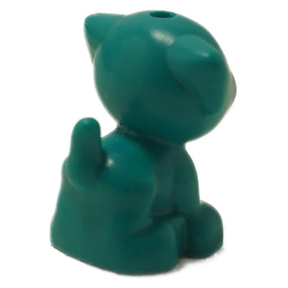 Puppy figure in dark turquoise with green paws and spot markings, shown from back angle
