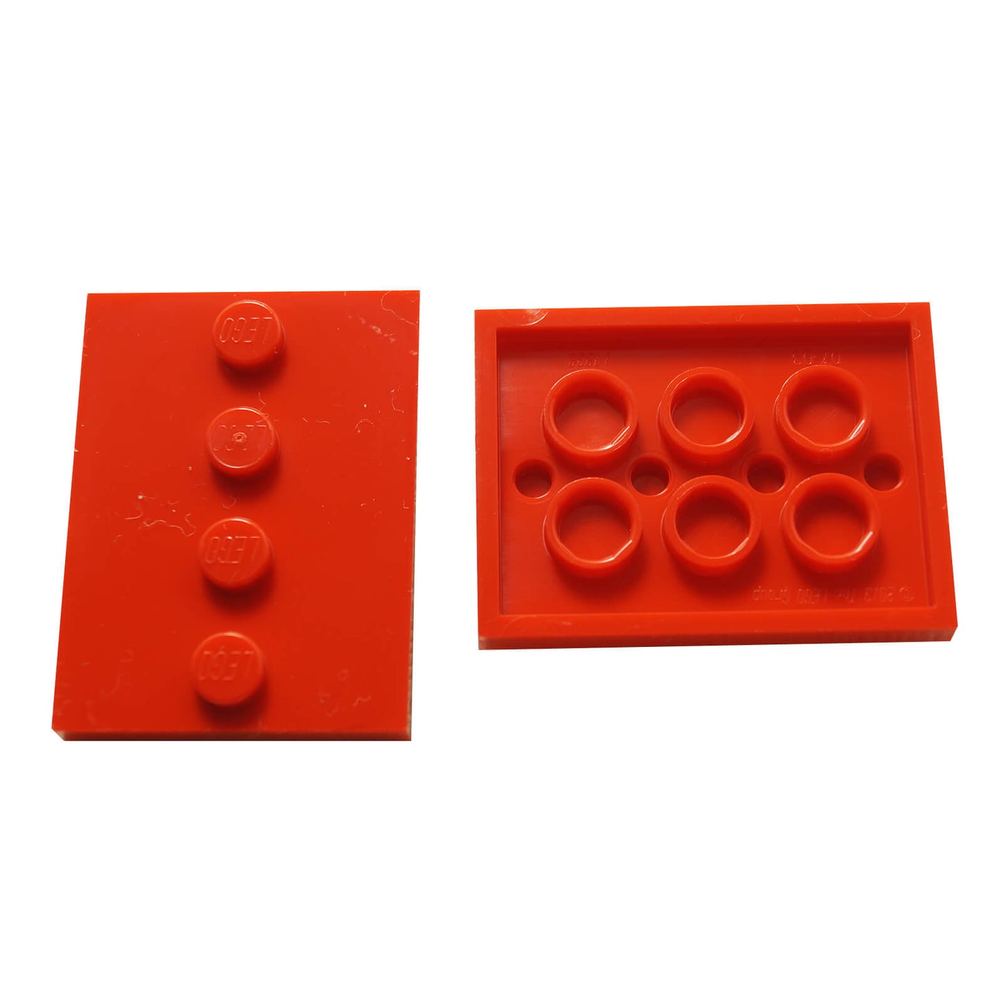 Red LEGO® modified 3 x 4 tile with four centered studs, ideal for decorative builds and detailing
