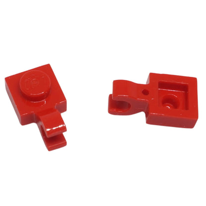 Red LEGO® modified plate 1 x 1 part 61252 shown from two angles with single stud and open horizontal O clip