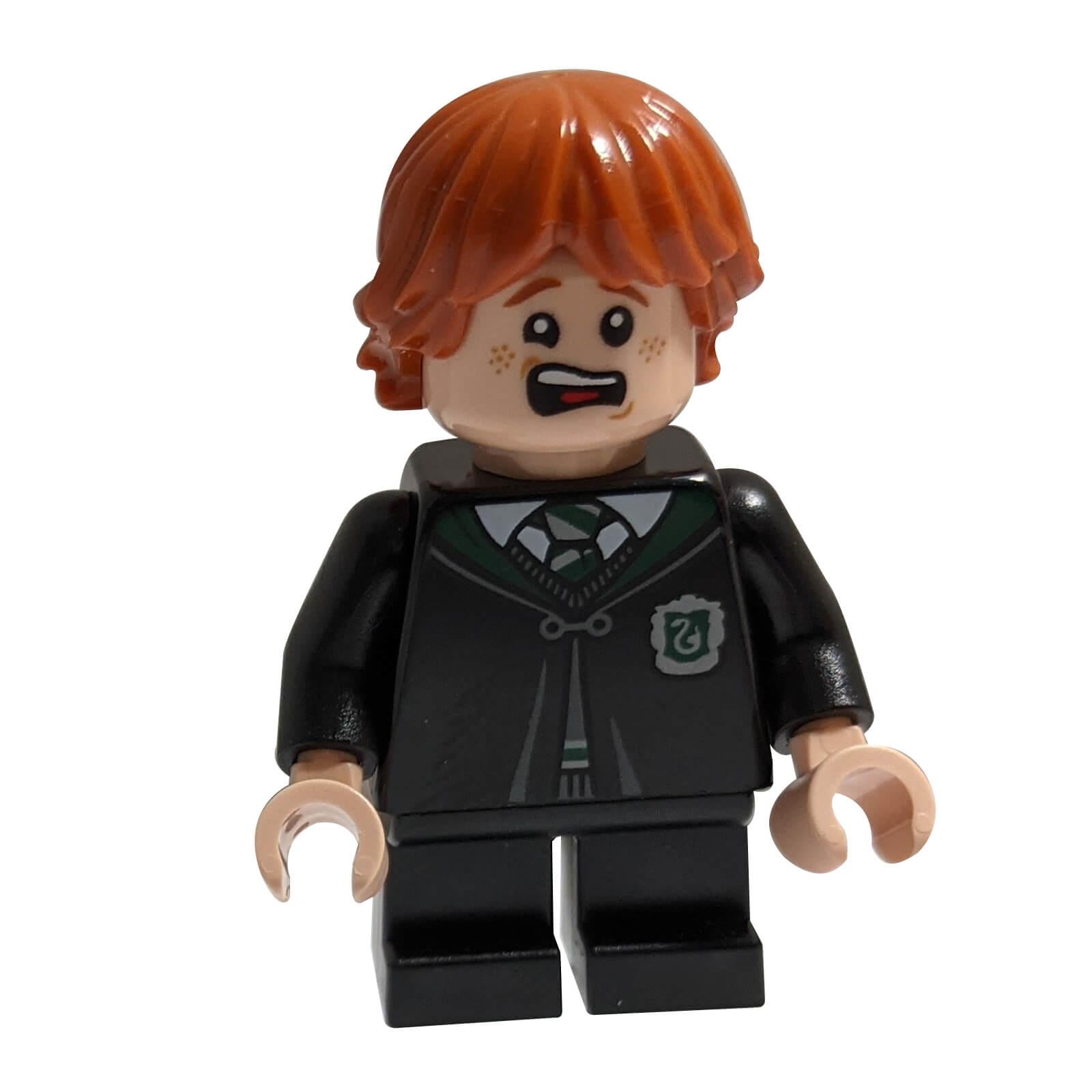 front view of LEGO Ron Weasley minifigure disguised as Vincent Crabbe wearing Slytherin school uniform with surprised freckled expression

