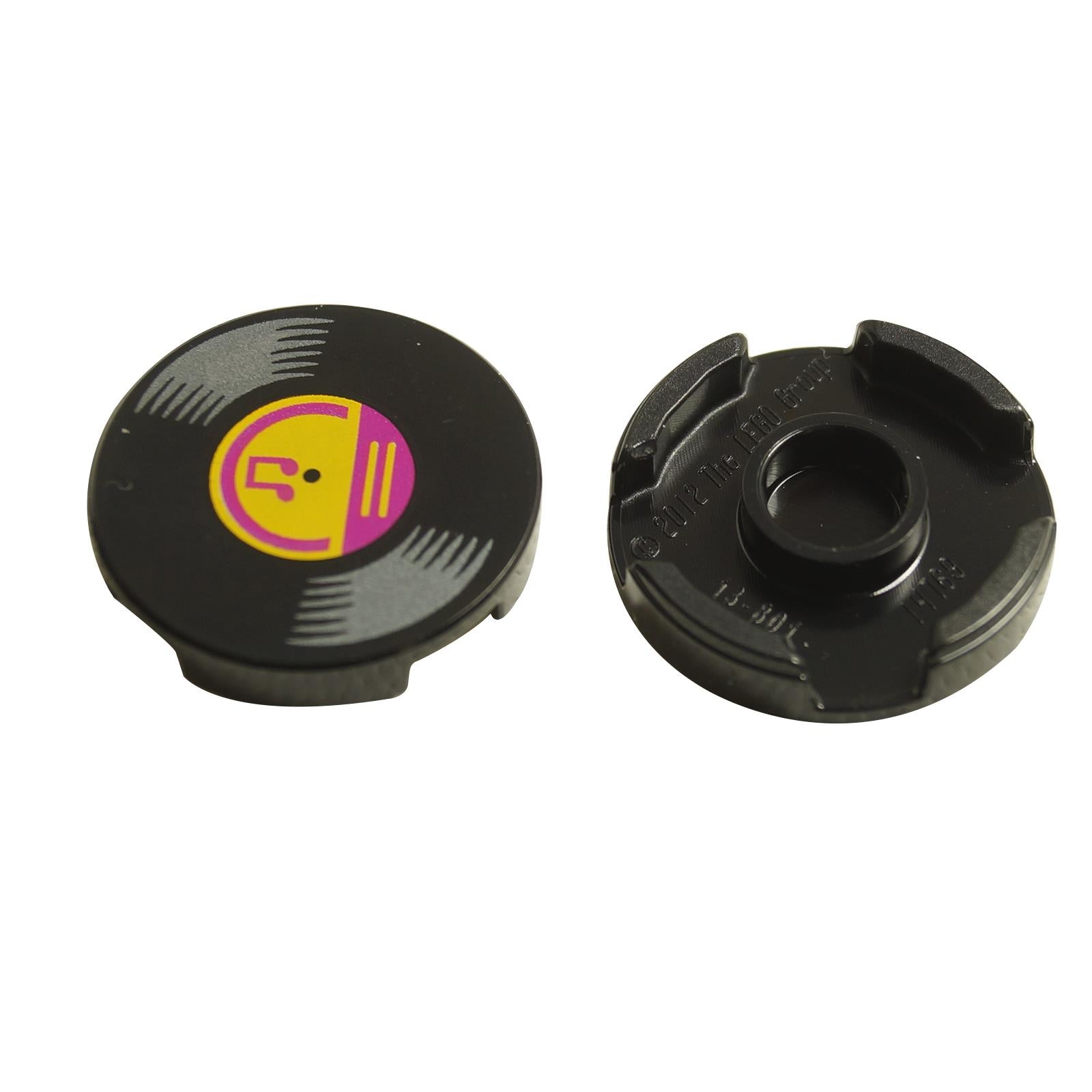 A round, black LEGO tile with a vinyl record design featuring musical notes and a bright light orange and magenta center.