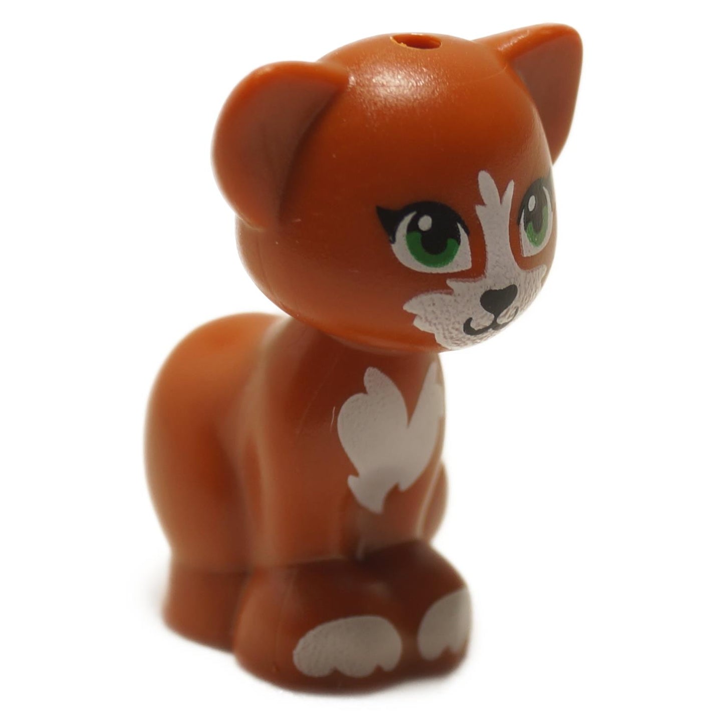 A LEGO minifigure of a dark orange cat with green eyes, black nose, and white patches, sitting in a pose.