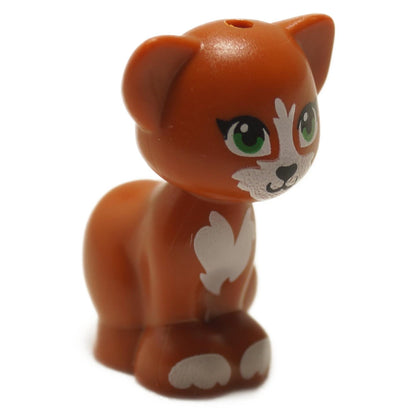 A LEGO minifigure of a dark orange cat with green eyes, black nose, and white patches, sitting in a pose.