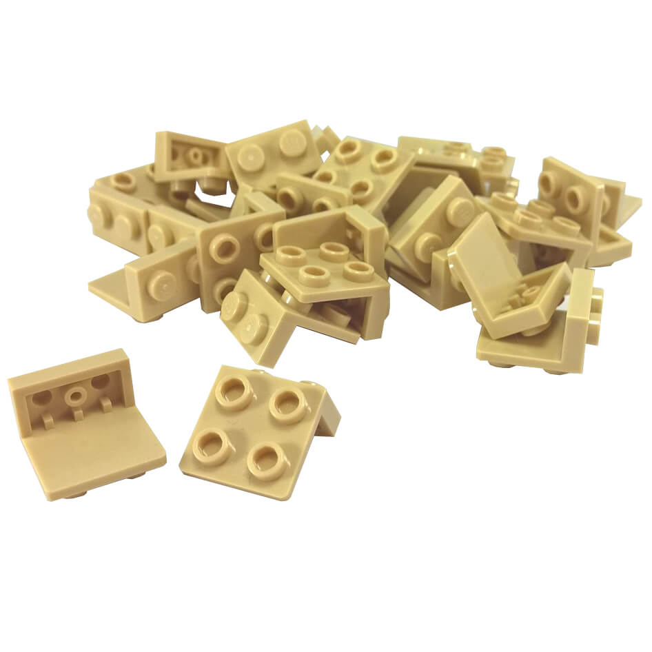 Pile of tan LEGO Bracket 1x2 - 2x2 pieces (44728) with one piece separated at the bottom left.