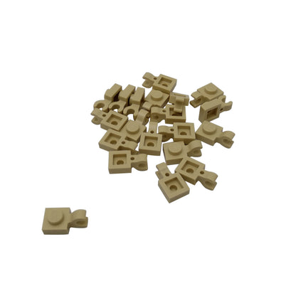Tan LEGO® modified plate 1 x 1 part 61252 shown from two angles with single stud and open horizontal O clip