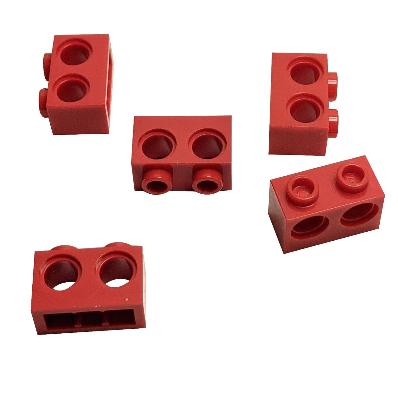 Five red Technic Brick 1 x 2 with Holes 32000 shown from various angles.