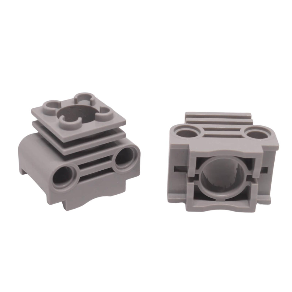LEGO Technic Engine Cylinder with bottom slots for piston and crankshaft clearance (Part 2850b) in light bluish gray.