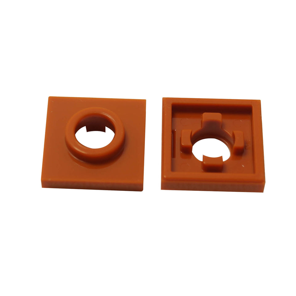 Dark orange modified 2x2 tile with large center hole, flat element used for detailing, vents, or axle pass-throughs
