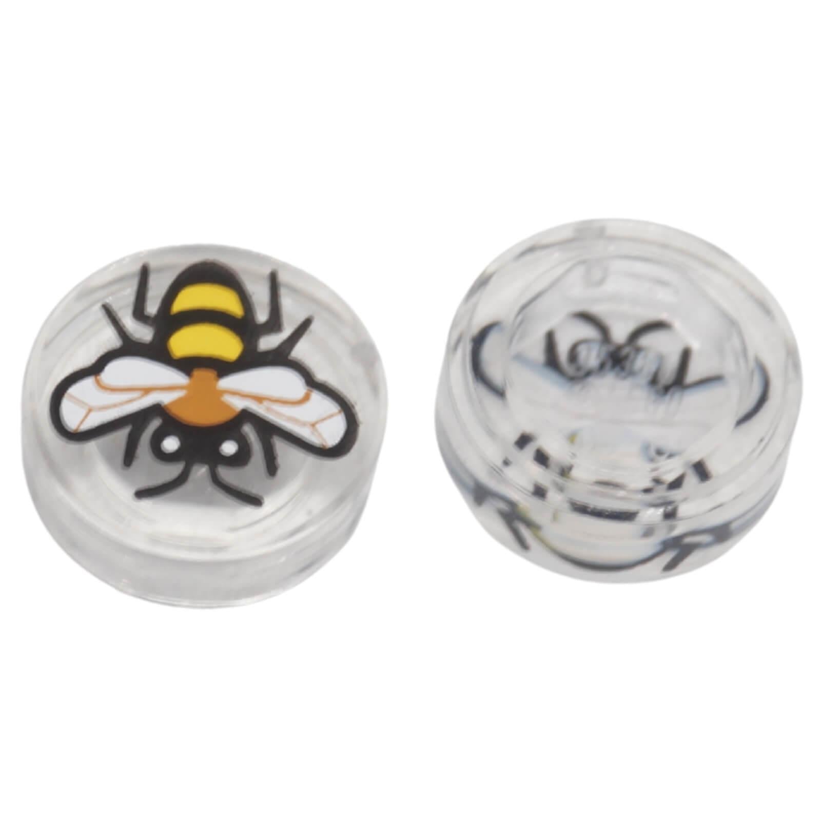 Top and underside view of LEGO® transparent round 1 × 1 tile 98138pb448 with a printed bee design