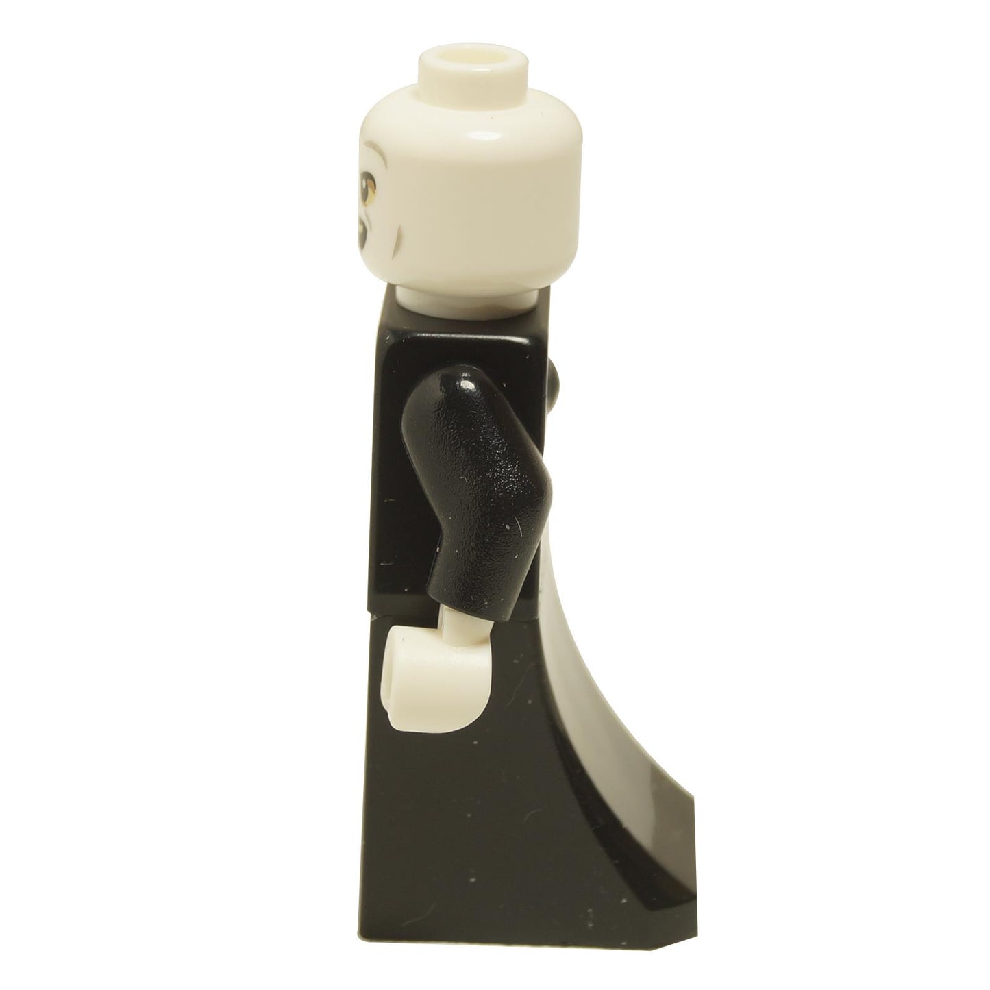 Side view of Lord Voldemort minifigure with white head, snake-like facial features, and black skirt piece