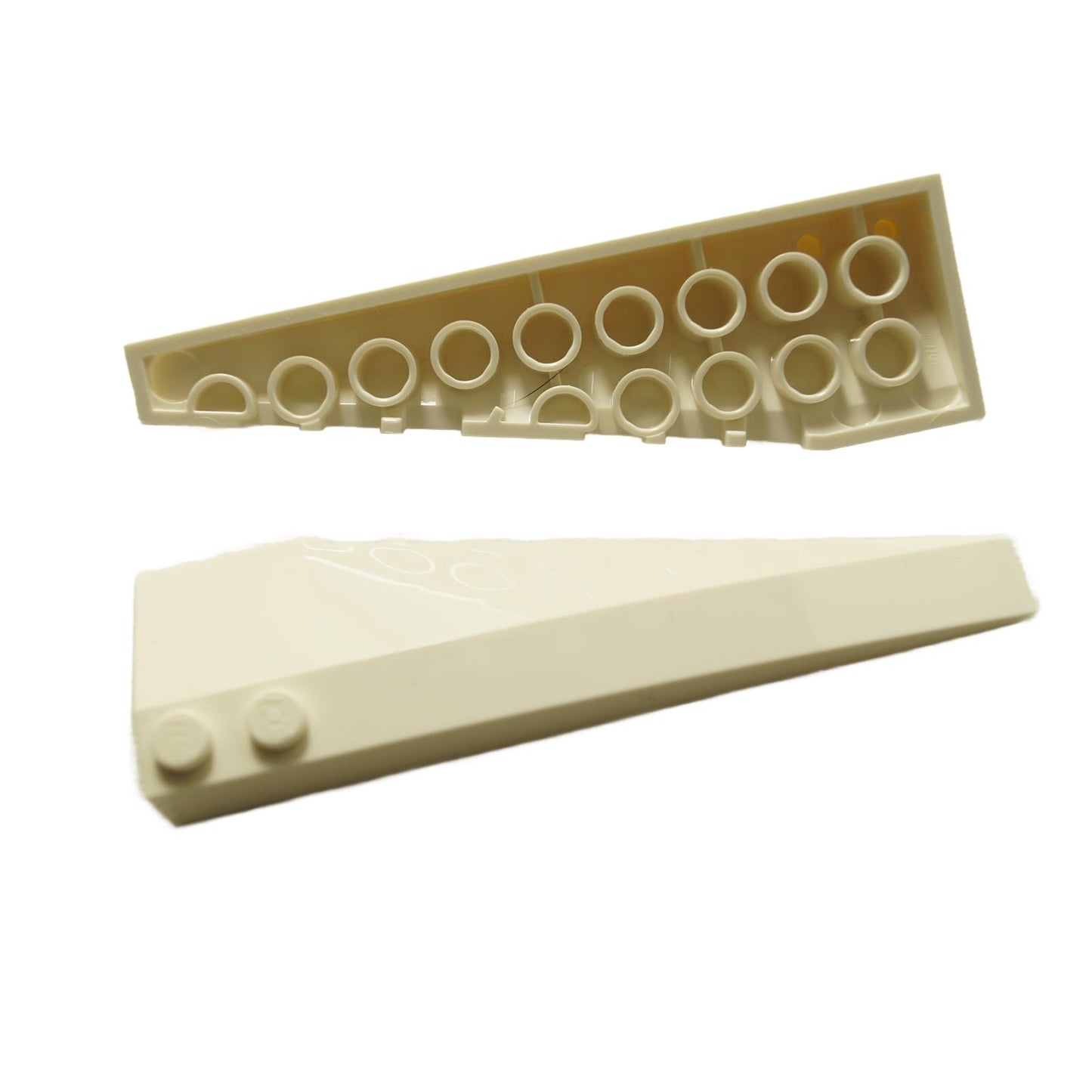 Top and bottom views of a white LEGO Wedge 10 x 3 Left, 50955.
