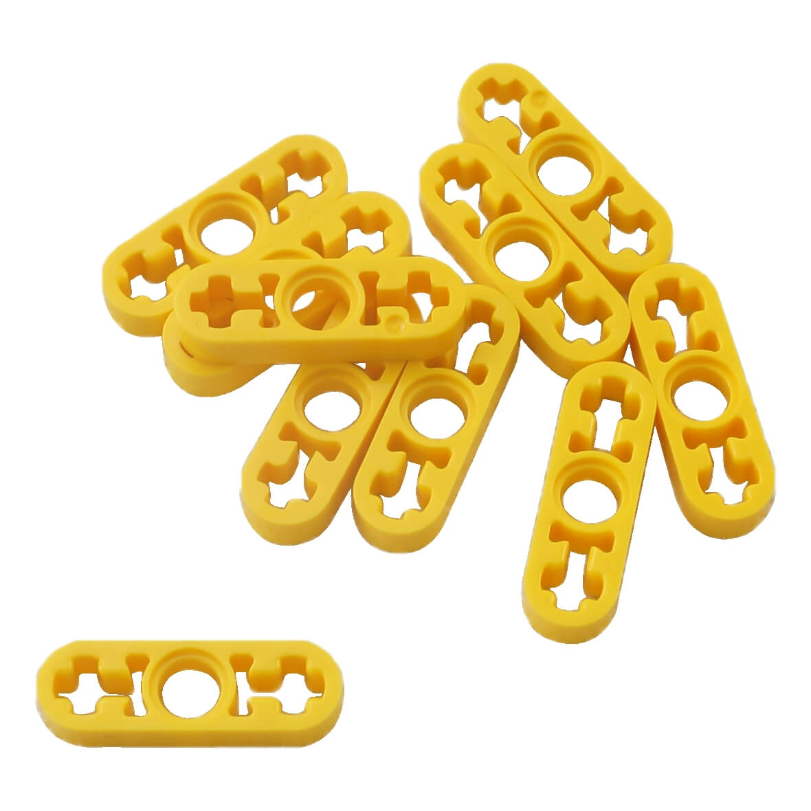 Un montón de piezas LEGO Technic Liftarm 1x3 Delgado de color amarillo brillante (6632) sobre una superficie blanca.