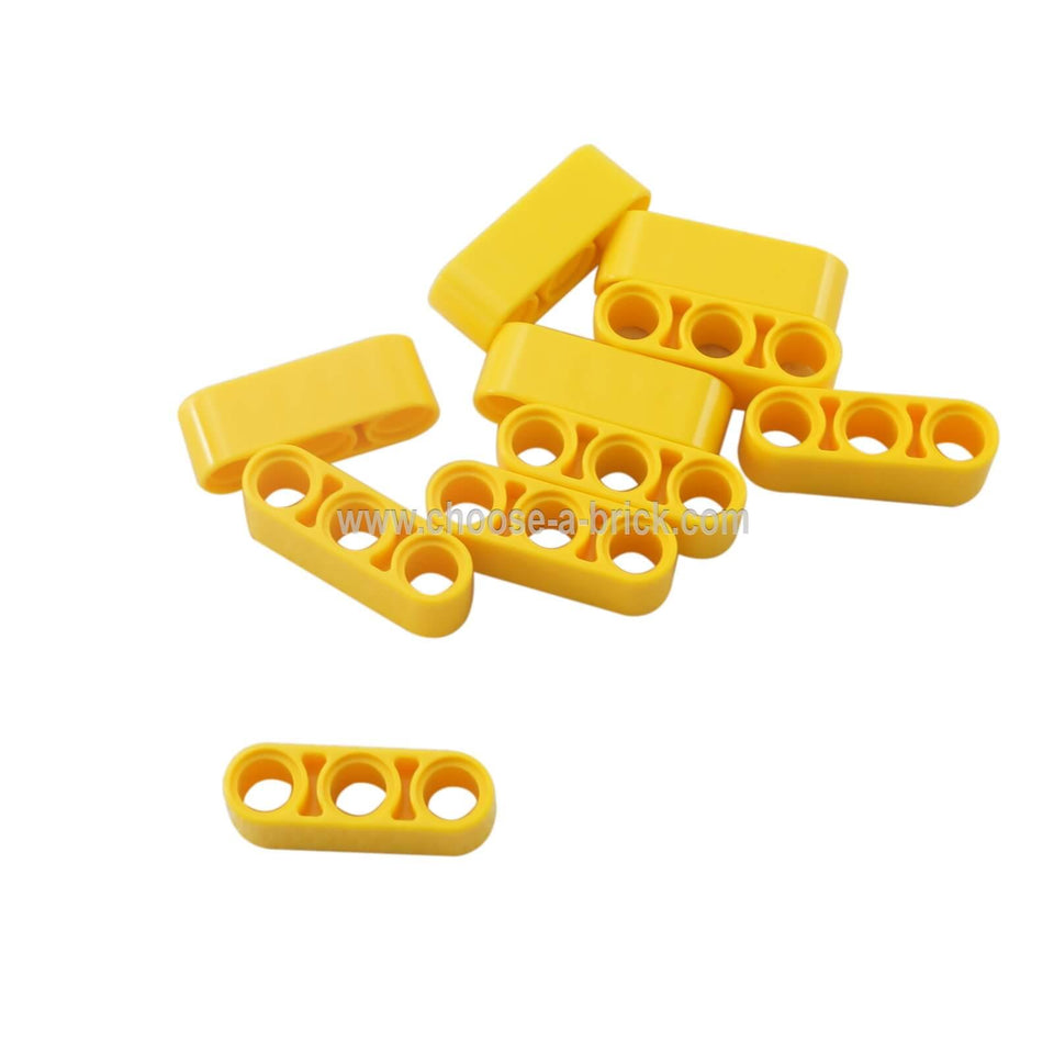 Pile of yellow LEGO Technic 1x3 Thick Liftarm pieces (32523) scattered together.